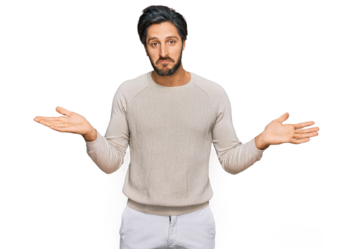 Young hispanic man wearing casual clothes clueless and confused expression with arms and hands raised. doubt concept.