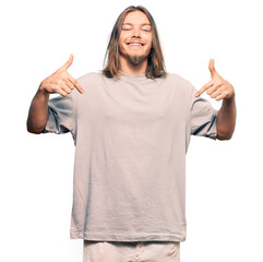 Handsome caucasian man with long hair wearing casual clothes looking confident with smile on face, pointing oneself with fingers proud and happy.