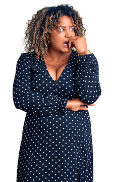Young african american plus size woman wearing casual clothes looking stressed and nervous with hands on mouth biting nails. anxiety problem.