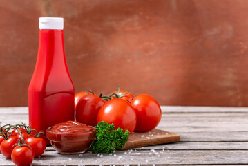 Bowl of ketchup or tomato sauce and tomatoes