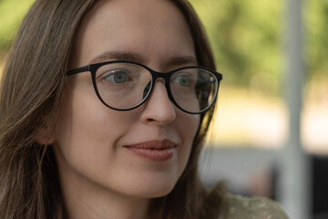 Portrait of thoughtful woman with glasses with designer frame, with prescription len. Eye care, vision problems concept.