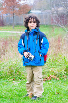A male child taking pictures outdoors