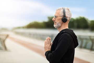 Retired senior man have yoga practice outdoor, copy space