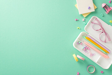 Creative school supplies arrangement. Overhead view of feminine stationery, pencil case, pens,...