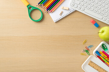 Convenience of studying online from home through this top-view image, highlighting keypad, notebook, colorful pencils and stationery on wooden isolated background. Space available for text or adverts