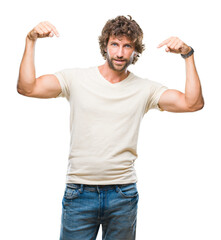 Handsome hispanic model man over isolated background looking confident with smile on face, pointing...