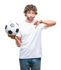 Obraz premium Handsome hispanic man model holding soccer football ball over isolated background with angry face, negative sign showing dislike with thumbs down, rejection concept