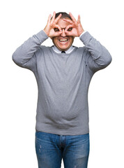 Middle age bussines arab man wearing glasses over isolated background doing ok gesture like binoculars sticking tongue out, eyes looking through fingers. Crazy expression.