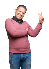 Middle age arab man over isolated background smiling with happy face winking at the camera doing victory sign. Number two.