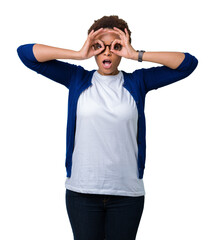 Young beautiful african american woman wearing glasses over isolated background doing ok gesture like binoculars sticking tongue out, eyes looking through fingers. Crazy expression.