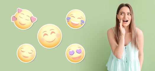Young gossiping woman and different smiling emoticons on green background