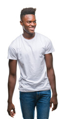 Young african american man over isolated background looking away to side with smile on face, natural expression. Laughing confident.