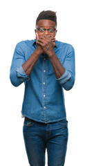 Young african american man over isolated background shocked covering mouth with hands for mistake. Secret concept.