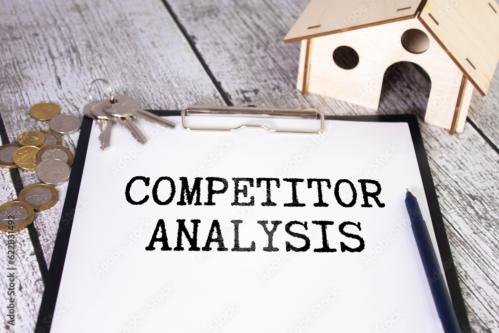 Poster competitor analysis text on a paper with keyboard, calculator on a grey background.