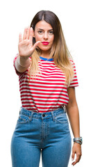 Young beautiful woman casual look over isolated background doing stop sing with palm of the hand. Warning expression with negative and serious gesture on the face.