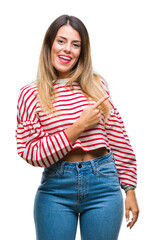 Young beautiful woman casual stripes winter sweater over isolated background cheerful with a smile of face pointing with hand and finger up to the side with happy and natural expression on face