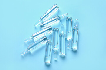 Naklejka premium Medical ampules on blue background