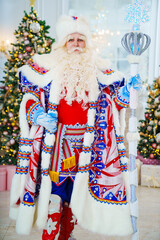 Fototapeta na wymiar portrait of Father Frost in traditional costume with stick staff. 