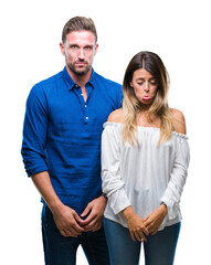 Young couple in love over isolated background depressed and worry for distress, crying angry and afraid. Sad expression.