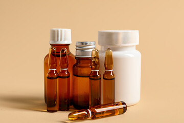 Ampules and bottles with medicines on beige background