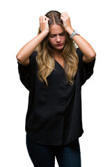 Young beautiful blonde woman over isolated background suffering from headache desperate and stressed because pain and migraine. Hands on head.