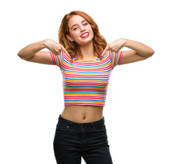 Young beautiful woman over isolated background looking confident with smile on face, pointing...