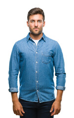 Young handsome man over isolated background with serious expression on face. Simple and natural looking at the camera.