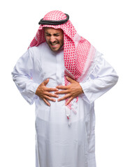 Young handsome man wearing keffiyeh over isolated background with hand on stomach because indigestion, painful illness feeling unwell. Ache concept.