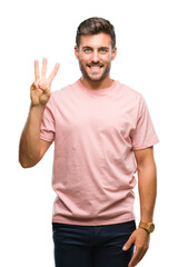 Naklejka premium Young handsome man over isolated background showing and pointing up with fingers number three while smiling confident and happy.
