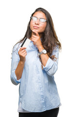 Young arab woman holding credit card over isolated background serious face thinking about question, very confused idea