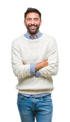 Adult hispanic man wearing winter sweater over isolated background happy face smiling with crossed...