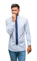 Adult hispanic business man over isolated background looking stressed and nervous with hands on mouth biting nails. Anxiety problem.