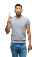 Naklejka premium Adult hispanic man over isolated background pointing finger up with successful idea. Exited and happy. Number one.