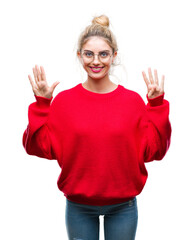 Young beautiful blonde woman wearing red sweater and glasses over isolated background showing and pointing up with fingers number nine while smiling confident and happy.