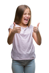 Fototapeta na wymiar Young beautiful girl over isolated background success sign doing positive gesture with hand, thumbs up smiling and happy. Looking at the camera with cheerful expression, winner gesture.