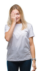 Fototapeta premium Young caucasian woman over isolated background covering one eye with hand with confident smile on face and surprise emotion.