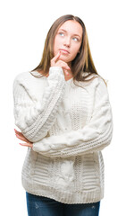 Young beautiful caucasian woman wearing winter sweater over isolated background with hand on chin thinking about question, pensive expression. Smiling with thoughtful face. Doubt concept.