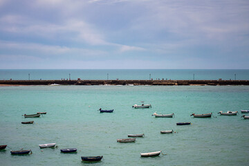 Boats on La Caleta beach in Cadiz, Spain on April 30, 2023