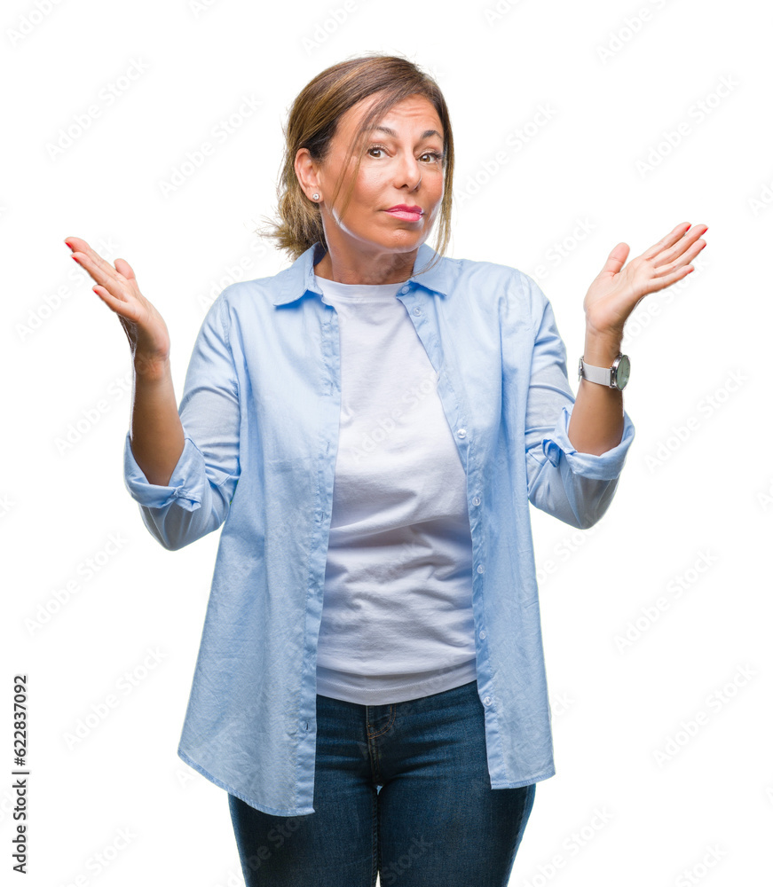 Poster Middle age senior hispanic woman over isolated background clueless and confused expression with arms and hands raised. Doubt concept.