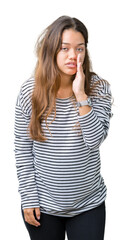 Fototapeta premium Young beautiful brunette woman wearing stripes sweater over isolated background hand on mouth telling secret rumor, whispering malicious talk conversation