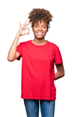 Beautiful young african american woman over isolated background smiling positive doing ok sign with hand and fingers. Successful expression.