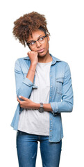 Beautiful young african american woman wearing glasses over isolated background with hand on chin thinking about question, pensive expression. Smiling with thoughtful face. Doubt concept.