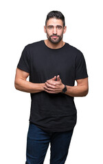 Young handsome man over isolated background Hands together and fingers crossed smiling relaxed and cheerful. Success and optimistic