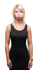 Fototapeta premium Young beautiful blonde attractive woman wearing elegant dress over isolated background puffing cheeks with funny face. Mouth inflated with air, crazy expression.