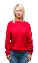 Young beautiful blonde woman wearing sweater and glasses over isolated background skeptic and nervous, frowning upset because of problem. Negative person.