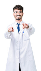 Young professional scientist man wearing white coat over isolated background Pointing to you and the camera with fingers, smiling positive and cheerful