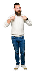 Young hipster man wearing winter sweater looking confident with smile on face, pointing oneself with fingers proud and happy.