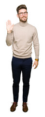 Young handsome business man wearing glasses Waiving saying hello happy and smiling, friendly...