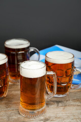 Mugs of cold beer on table. Oktoberfest celebration