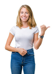 Beautiful young woman wearing casual white t-shirt over isolated background smiling with happy face looking and pointing to the side with thumb up.